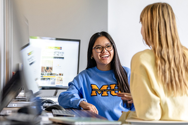 Undergraduate students working next to computers