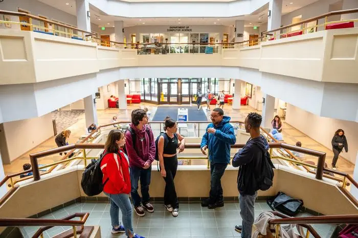 Students talking near some stairs.