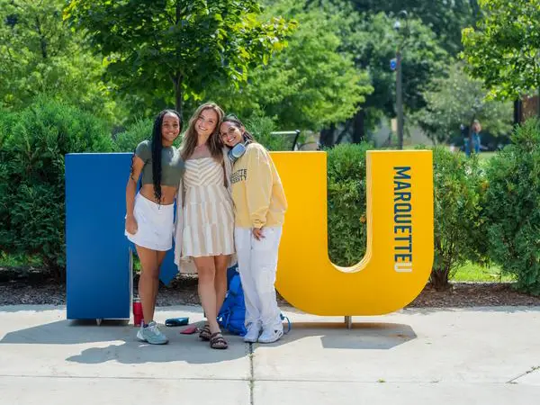 mu students in front of MU letters