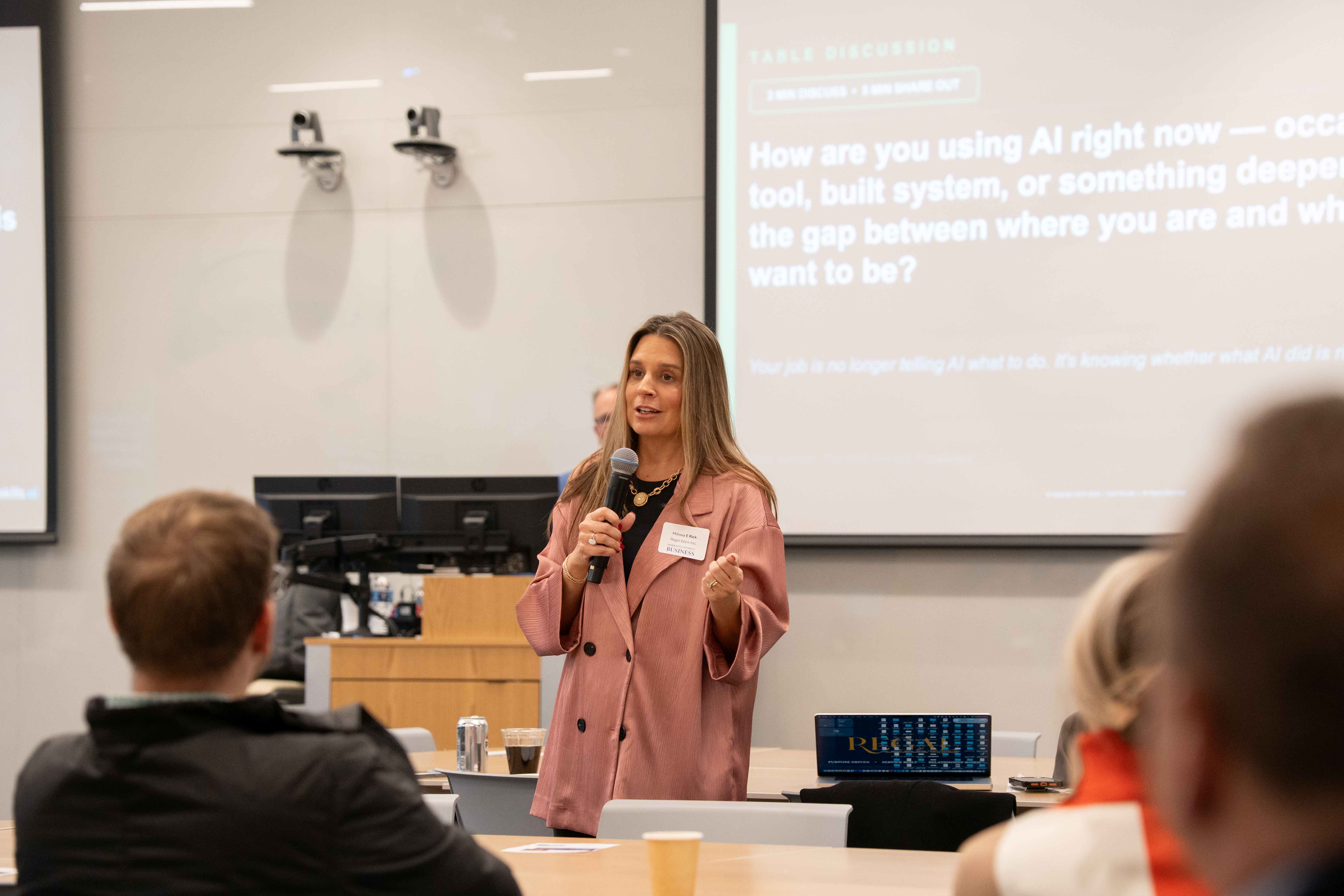 professional speaks to attendees about using AI for business