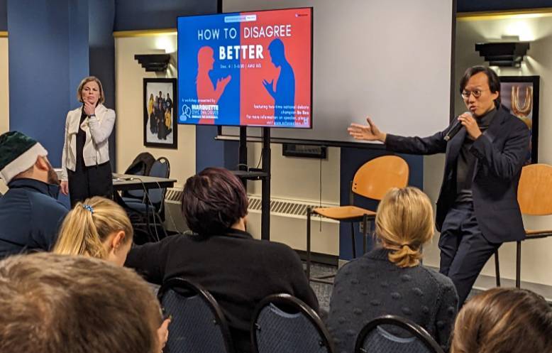 Two-time world debate champion Bo Seo (right) facilitates a workshop on how to disagree better.