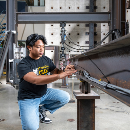 student analyzing a steel beam