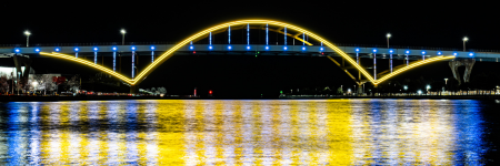 Hoan bridge lit up with blue and gold colors