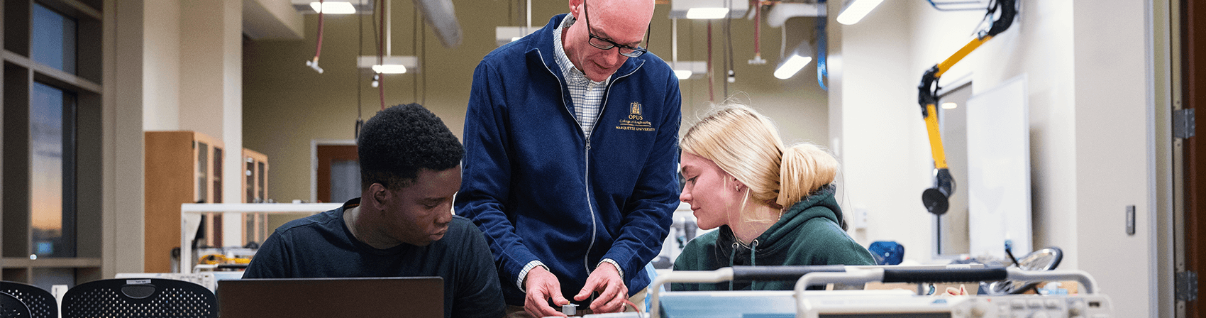 Dr. Phil Voglewede with two students