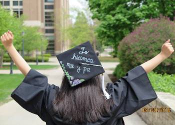 marquette student graduates - cap translates 'we made it mom and dad!'