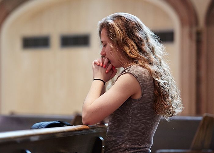 Student praying in Gesu Church