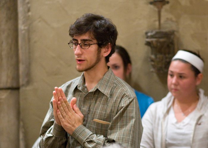 Students praying at Mass in St. Joan of Arc Chapel