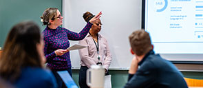 Graduate school educators with a degree in secondary education talking on campus