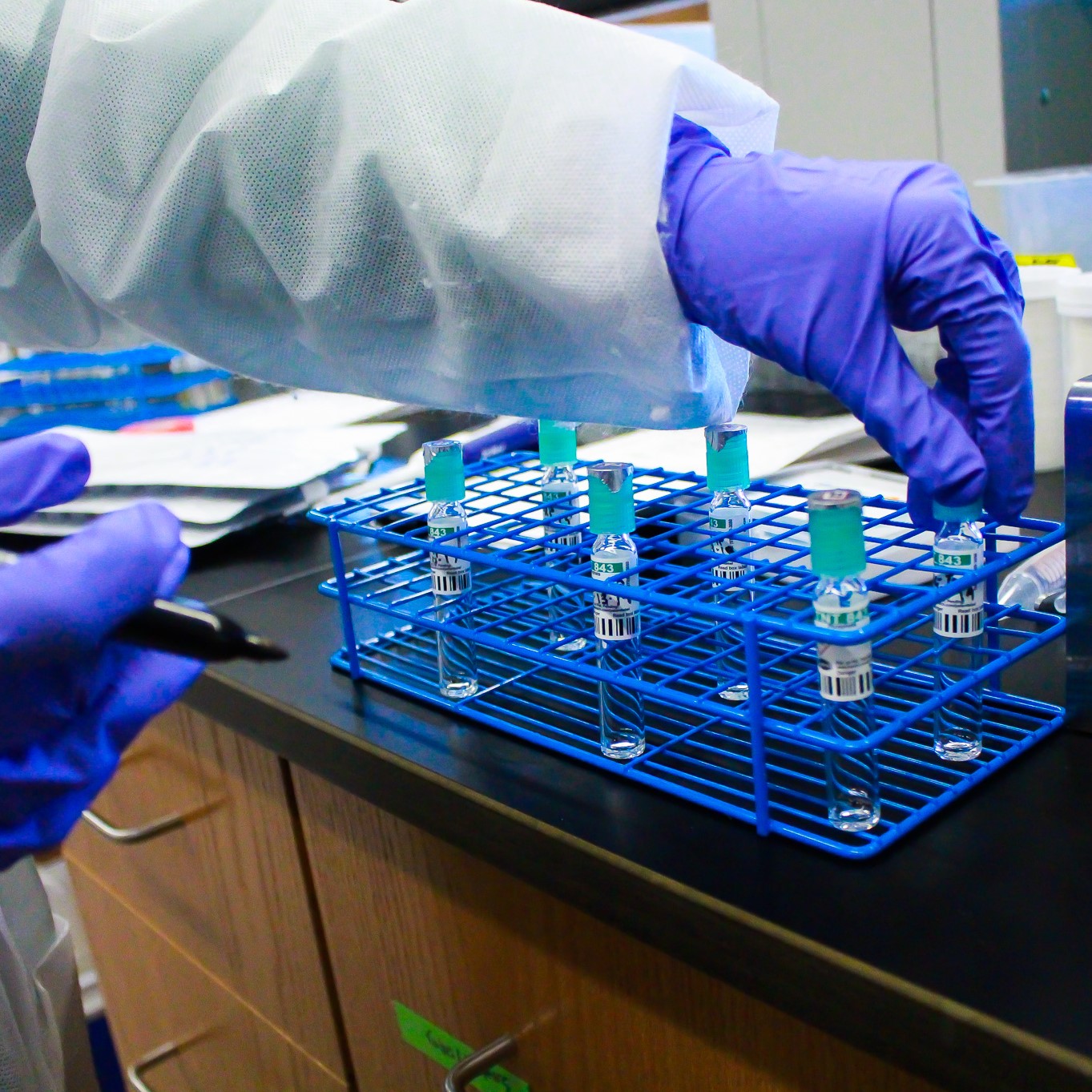 A student marks test tubes at the Global Water Center