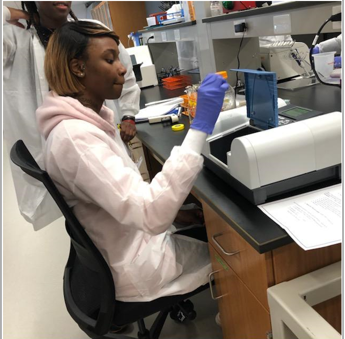 A Project Water student samples water.