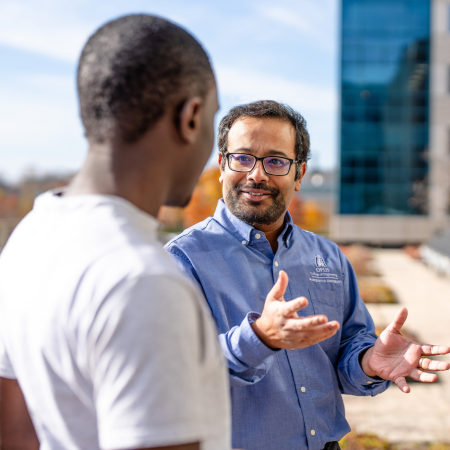 faculty member talking to a student outside