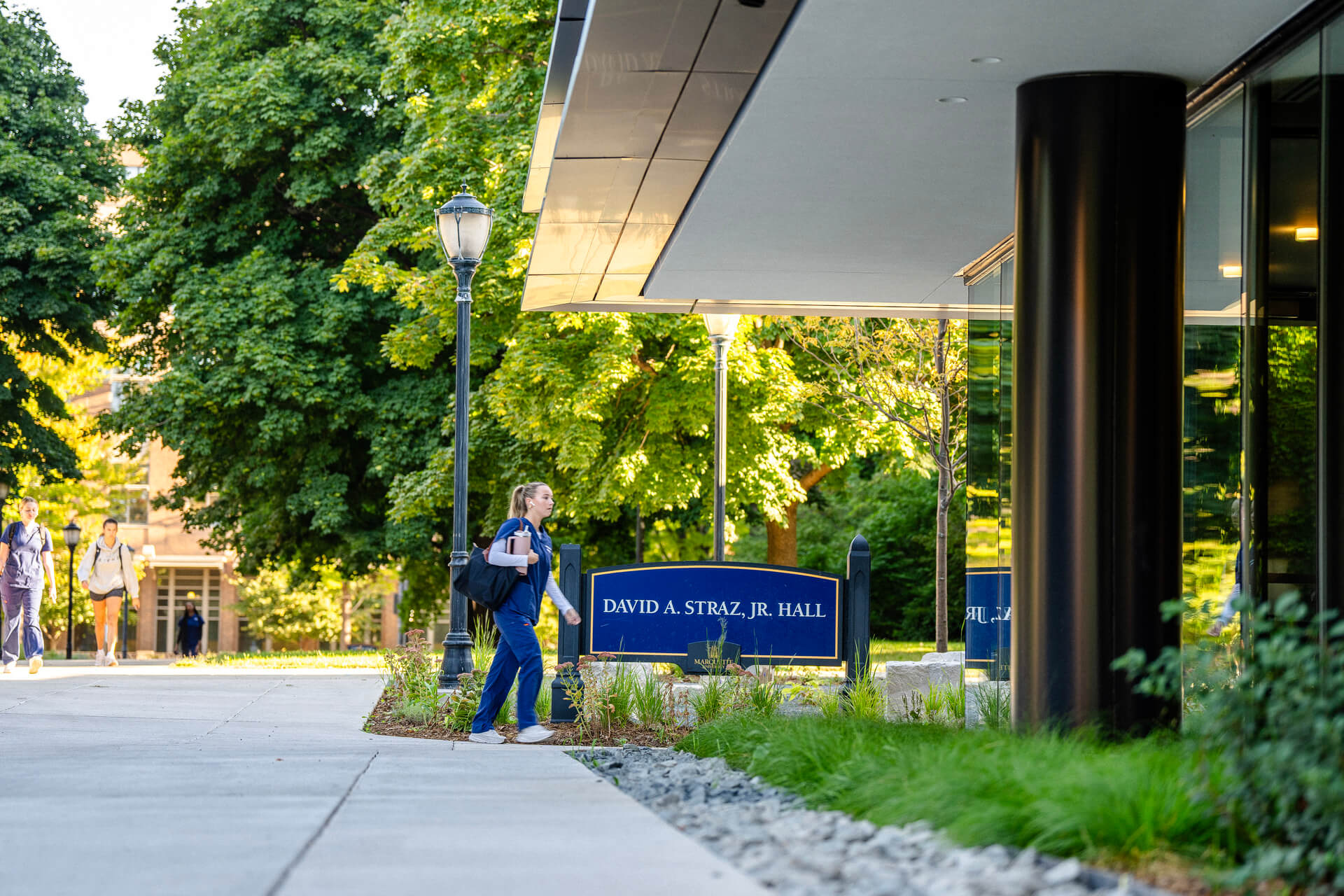 Student walking into Nursing building