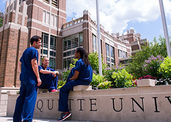 Students gather at the entrance to Raynor Library