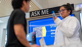 student at the ask me desk