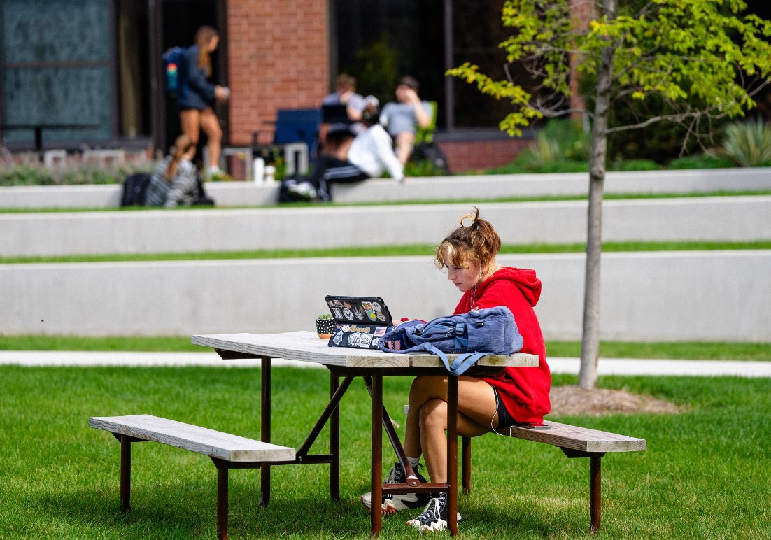 Student studying outside AMU