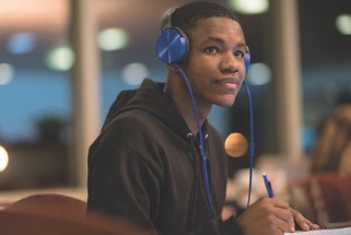 Student with headphones on studying