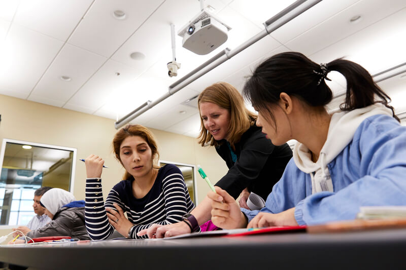 teacher helping students